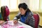 Woman factory worker with needle. North Korea