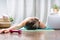 Woman falling asleep. Tired after exercise and workout. Overtraining concept. Exhausted woman lying on floor and resting after