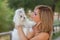 Woman with family pet Maltese dog