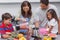 Woman with family pouring fruit from a blender