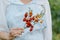 woman farmer or agronomist in light apron in garden with wicker basket of red tomatoes