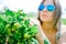 Woman farmer is checking maturing gooseberry