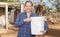 Woman farmer feeds poultry in the backyard of the farm