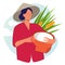 Woman farmer holding basket wearing cap in rice padi field harvesting. Traditional farming organic nature