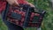 A woman farmer holds a box of organic tomatoes in her hands.