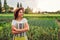 Woman farmer looking at vegetables on kitchen-garden in countryside. Agriculture and farming concept