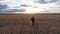 A woman farmer monitors the wheat crop. Aerial survey. Wheat field top view. 4K slow motion video