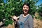 Woman farmer shows a heap of white grapes