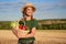 Woman farmer straw hat apron standing farmland smiling Female agronomist specialist farming agribusiness Happy positive caucasian