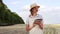 Woman farmer straw hat smart farming standing farmland smiling using digital tablet Female agronomist specialist