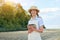 Woman farmer straw hat smart farming standing farmland smiling using digital tablet Female agronomist specialist research