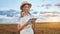 Woman farmer straw hat smart farming standing farmland smiling using digital tablet Female agronomist specialist research
