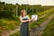 Woman farmer working in fruit garden and shows the level of crop growth using infographics. Biologist inspector examines