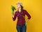 Woman farmer on yellow background enjoying fresh parsley