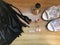 Woman fashion flat lay. Black leather skirt with fringe with red lipstick, nail valish, perfume, white shoes with heels and Wow