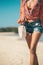 Woman with fashionable stylish rattan bag and silk scarf outside. Tropical island of Bali, Indonesia. Rattan handbag and