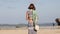 Woman with fashionable stylish yellow white bag on the beach. Tropical island of Bali. Handmade Rattan eco handbag HD