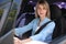 Woman with fastened safety belt on driver`s seat in car