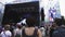 Woman in fedora hat dancing little bit in crowd near scene at summer festival