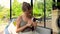 Woman feeding cute little rabbit carrot from hands, carefully holding him