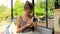 Woman feeding cute little rabbit carrot from hands, carefully holding him