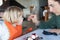 Woman feeding little kid with spoon chocolate cake