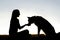 Woman Feeding Pet Dog Treats Silhouette