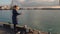 Woman feeding seagulls on the waterfront