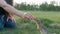 Woman feeding squirrel in the park. Gopher takes the food out of hand. Kindness and care for animals.