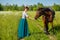 Woman feeds a horse with hands favorite animal