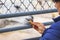 A woman feeds a llama carrot through a zoo fence_