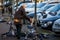 Woman feeds pigeon birds on the street