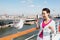 Woman feeds seagull on deck of ship.