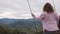 Woman feel freedom in beautiful mountain and fly on swing