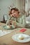 Woman feeling lonely sitting near her cake and champagne alone