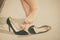 Woman feeling pain after wearing high heels