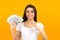 Woman feeling super happy holding fan of dollar money