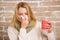 Woman feels badly ill sneezing. Cold and flu remedies. Girl in scarf hold tissue or napkin suffer headache. Runny nose