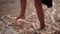 Woman feet barefoot in sea of foam waves on beach summer day approaches