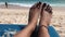 Woman feet on a beach chair on the paradise tropical beach of Bali island, Indonesia.