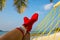 Woman feet with christmas sock in hammock on the beach