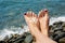 Woman feet closeup of girl relaxing on beach