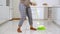 Woman feet dancing while cleaning floor