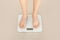 Woman feet on electronic floor scales, cropped shot