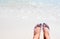 Woman feet on hot sunny beach. Relaxed barefoot tourist by sea. Seaside banner template.