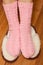 Woman feet in knitted woolen socks standing on fluffy slippers