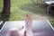 Woman feet on pool lounger sunbathing