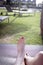 Woman feet on pool lounger sunbathing