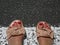 Woman feet in sandals on the pedestrian crossing