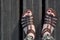 Woman feet seen from above. Sandals and red nails